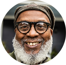 Smiling older man wearing glasses and a beanie hat