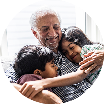 Grandfather holding his grandchildren and smiling