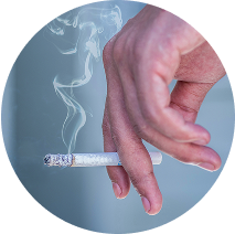 Close up of a hand holding a lit cigarette