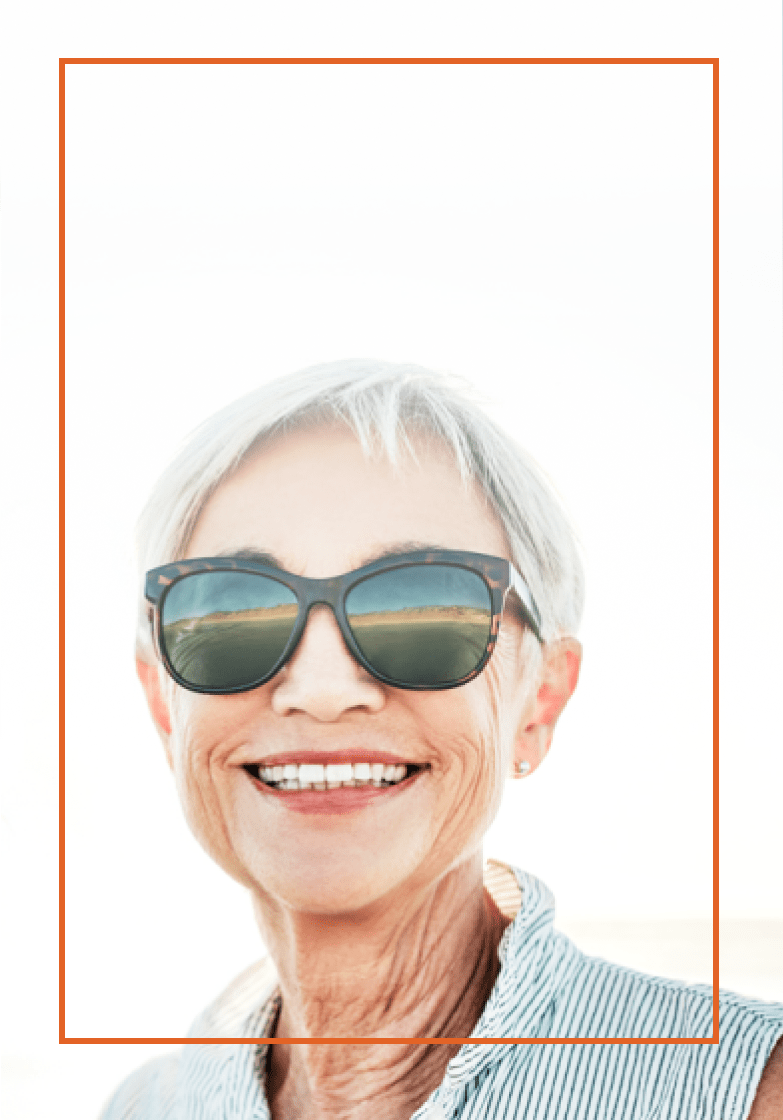 Older woman wearing sunglasses and smiling