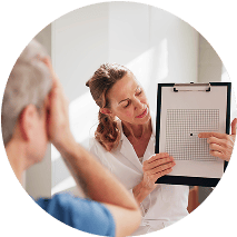 Doctor giving an eye exam to a patient