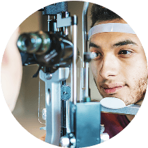 Man with his face placed in an eye exam device
