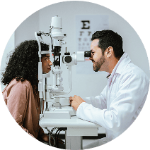 Doctor administering an eye exam with a device