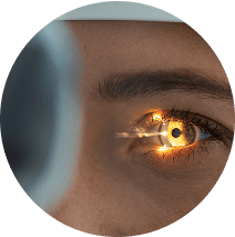 Close up of a light being shined into an eye during an eye exam
