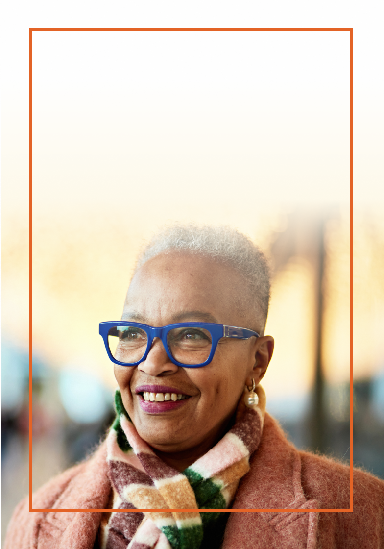 Elderly woman with blue glasses that is smiling