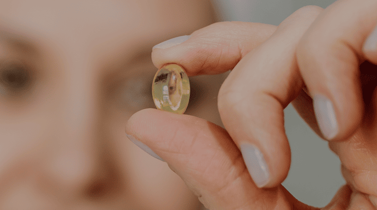 women with a eye pill