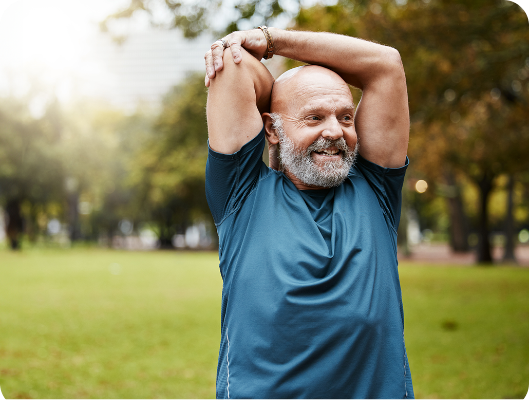 Older man in a blue shirt stretching outside