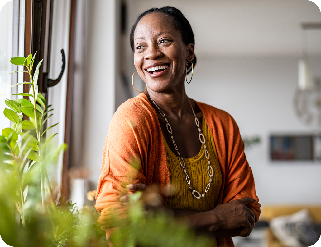 Woman standing near window smiling